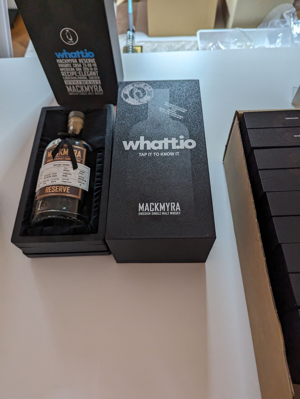 A 3D-printed whatt.io Mackmyra whisky presentation case, UV-printed, with the bottle nestled in black velvet