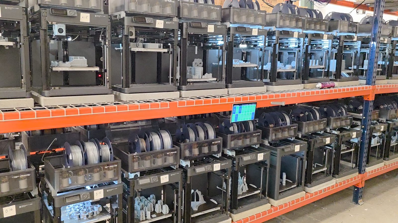 ...to a 650m2 (about 7,000 sq ft) warehouse of orange racks, running on SimplyPrint.