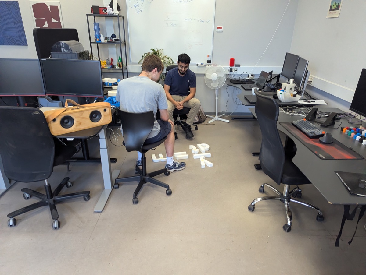 Assembling 3D-printed letters at the office